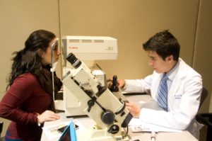 Medical student giving eye exam|CC BY-SA 3.0